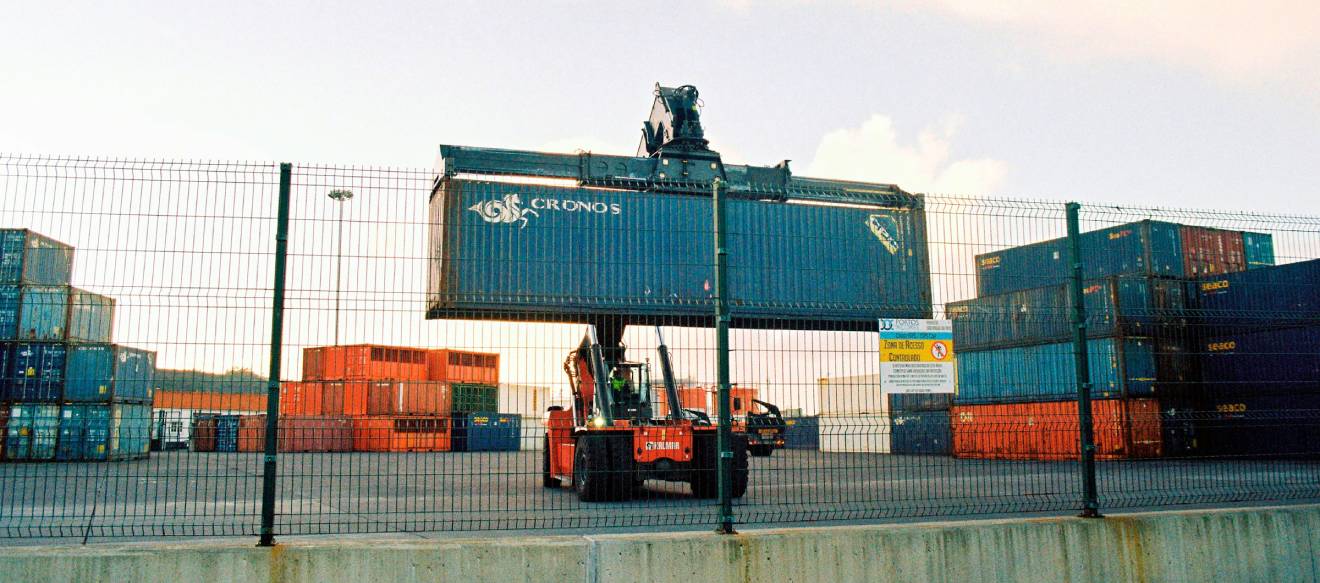 A picture of a container being loaded in container depot facility